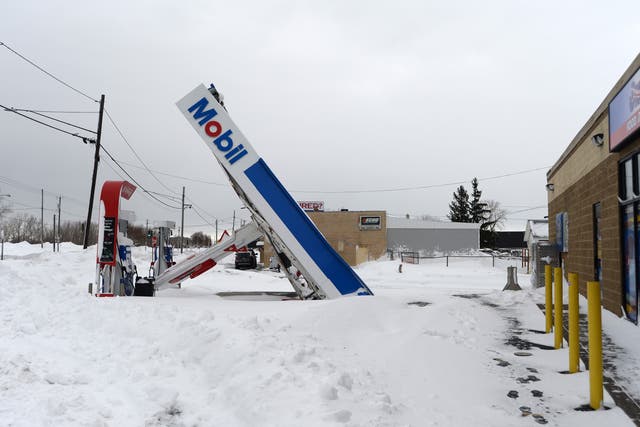 <p>A gas station canopy lays on its side after high winds and heavy snow in Lackawanna, New York</p>