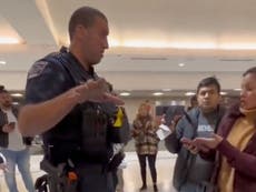 Airport police officer threatens to arrest stranded passengers waiting to rebook cancelled Southwest flights