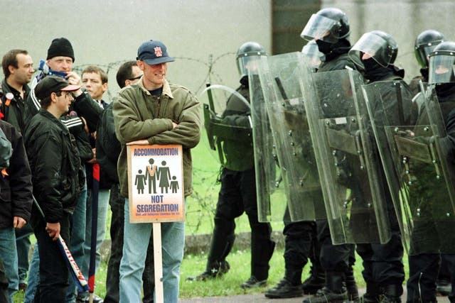 Loyalists take a stand in front of a line of Royal Ulster Constabulary police near the Garvaghy Road, Portadown during the Drumcree standoff in 1998 (PA)
