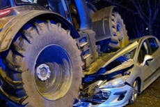 Three people taken to hospital after car crushed under tractor
