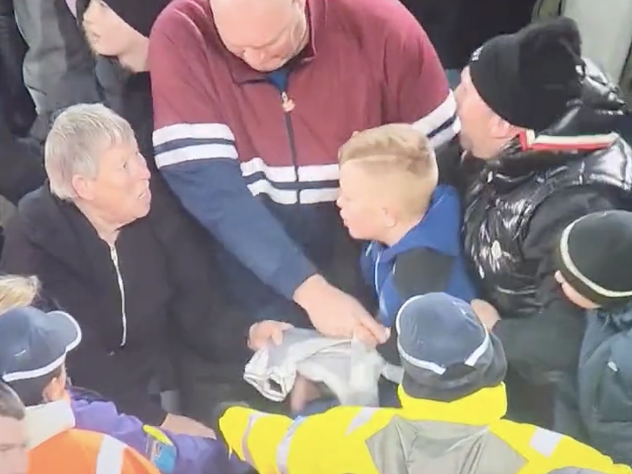 Paula Dodds, NJ, and two men wrestle over the Newcastle jersey