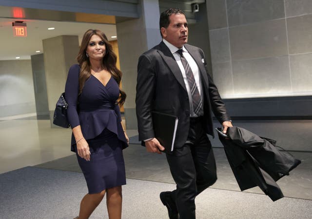 <p>Kimberly Guilfoyle leaves a meeting with the January 6 committee in April 2022 flanked by an aide</p>