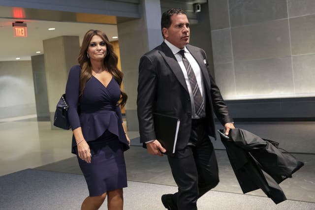 <p>Kimberly Guilfoyle leaves a meeting with the January 6 committee in April 2022 flanked by an aide</p>