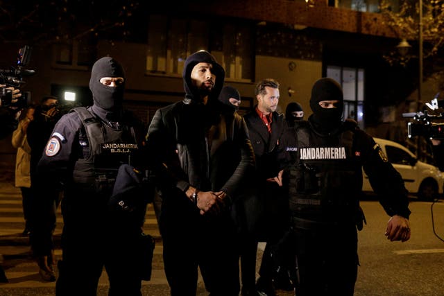 <p>Andrew Tate and Tristan Tate are escorted by police officers outside the headquarters of the Directorate for Investigating Organized Crime  in Bucharest </p>