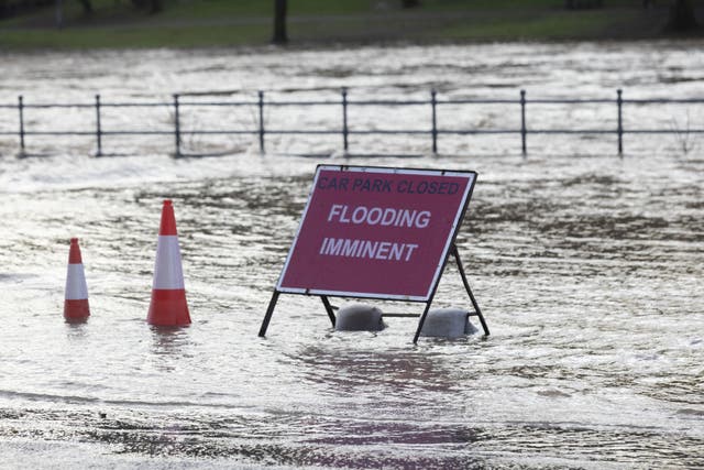 A flood warning sign at the entrance to a flooded car park in Whitesands, Dumfries (Robert Perry/PA)