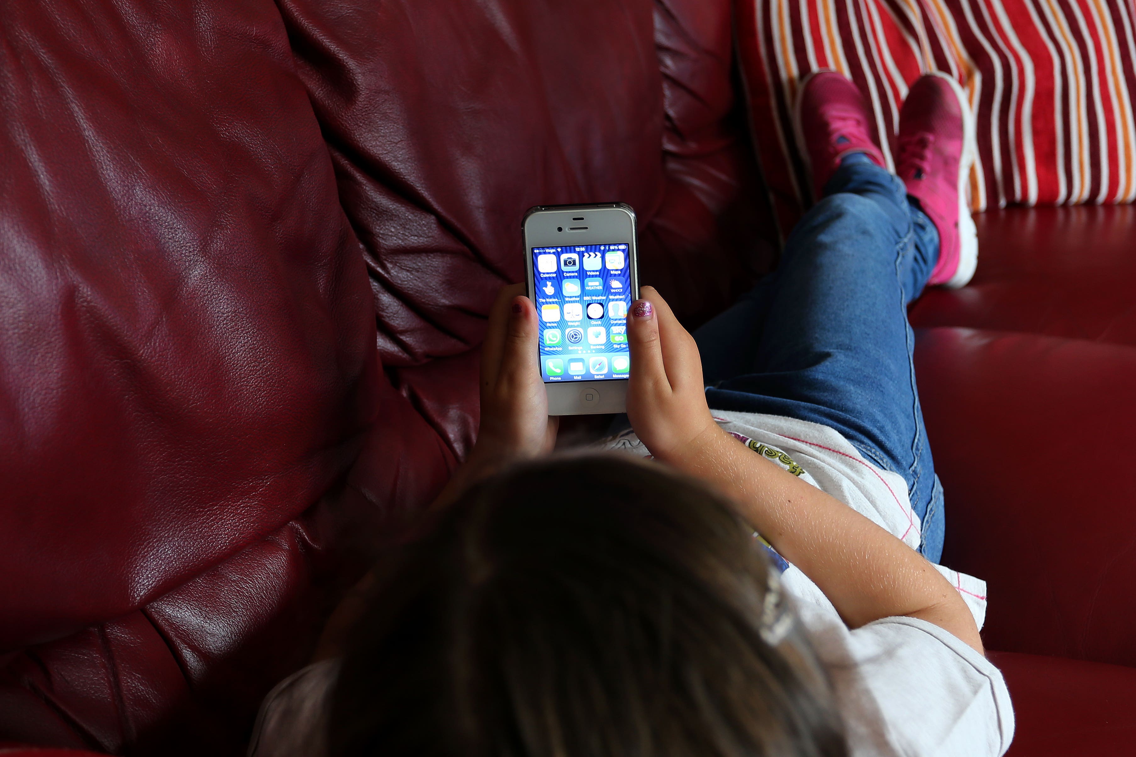 A child using an Apple iPhone smartphone (Peter Byrne/PA)