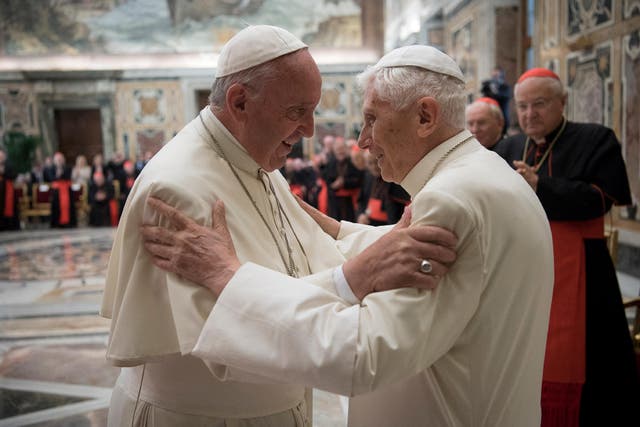 <p>Former Pope Benedict, right, is greeted by Pope Francis in 2016 </p>