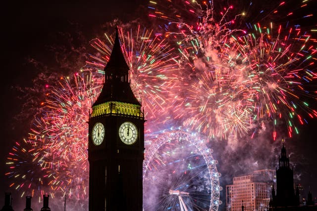 Fireworks light up the sky over the London Eye and the Elizabeth Tower (Big Ben) in central London during the New Year celebrations (Aaron Chown/PA)