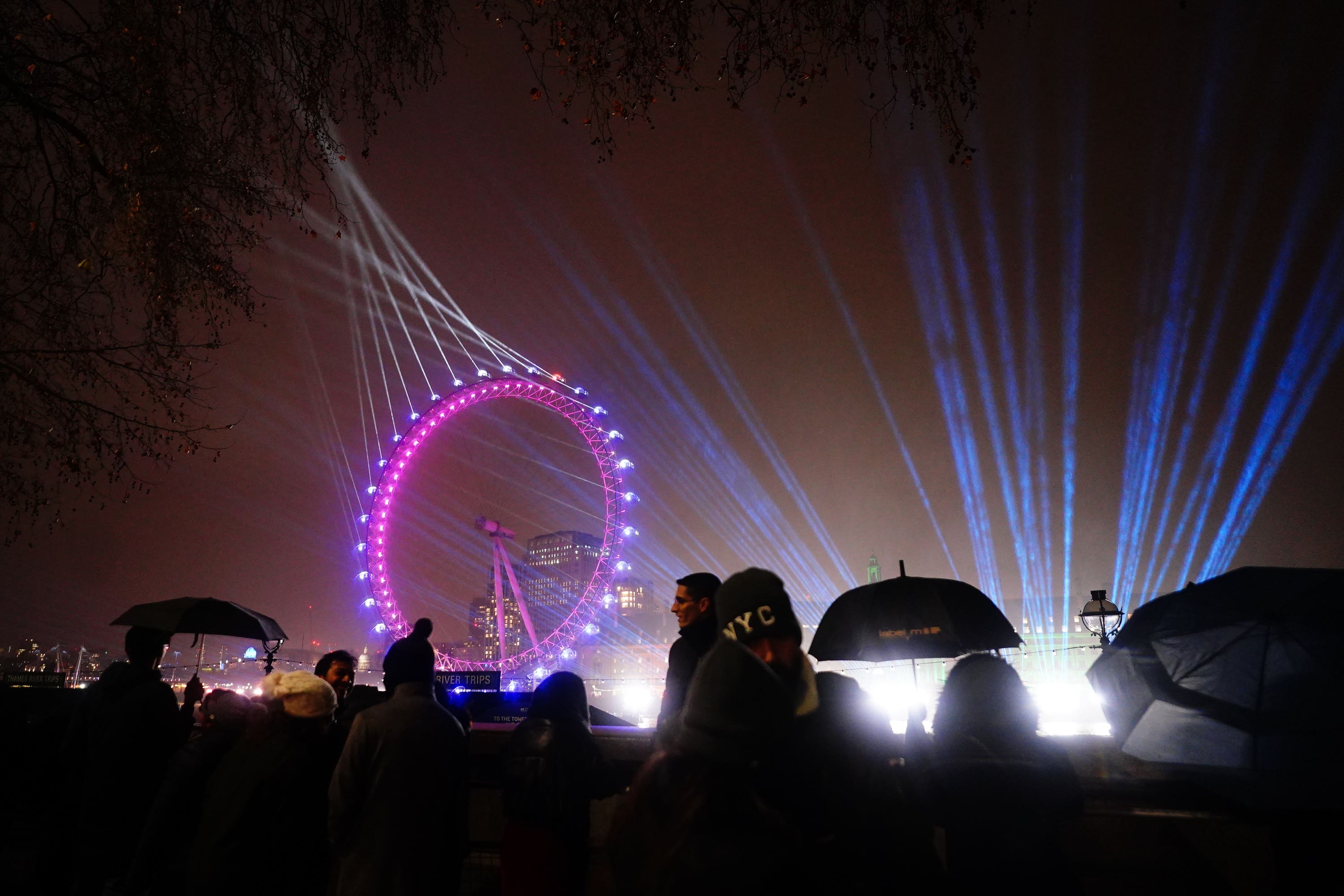 People gather on the Embankment opposite the London Eye(Victoria Jones/PA)