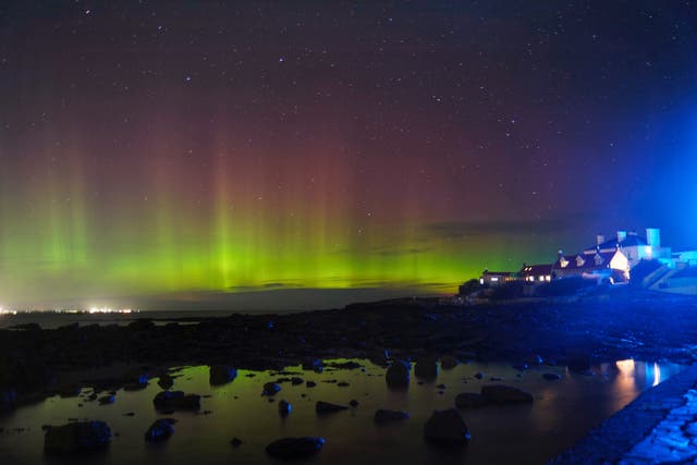 <p>The aurora borealis, better known as the northern lights, over St Mary’s Island, North Tyneside (Owen Humphreys/PA)</p>