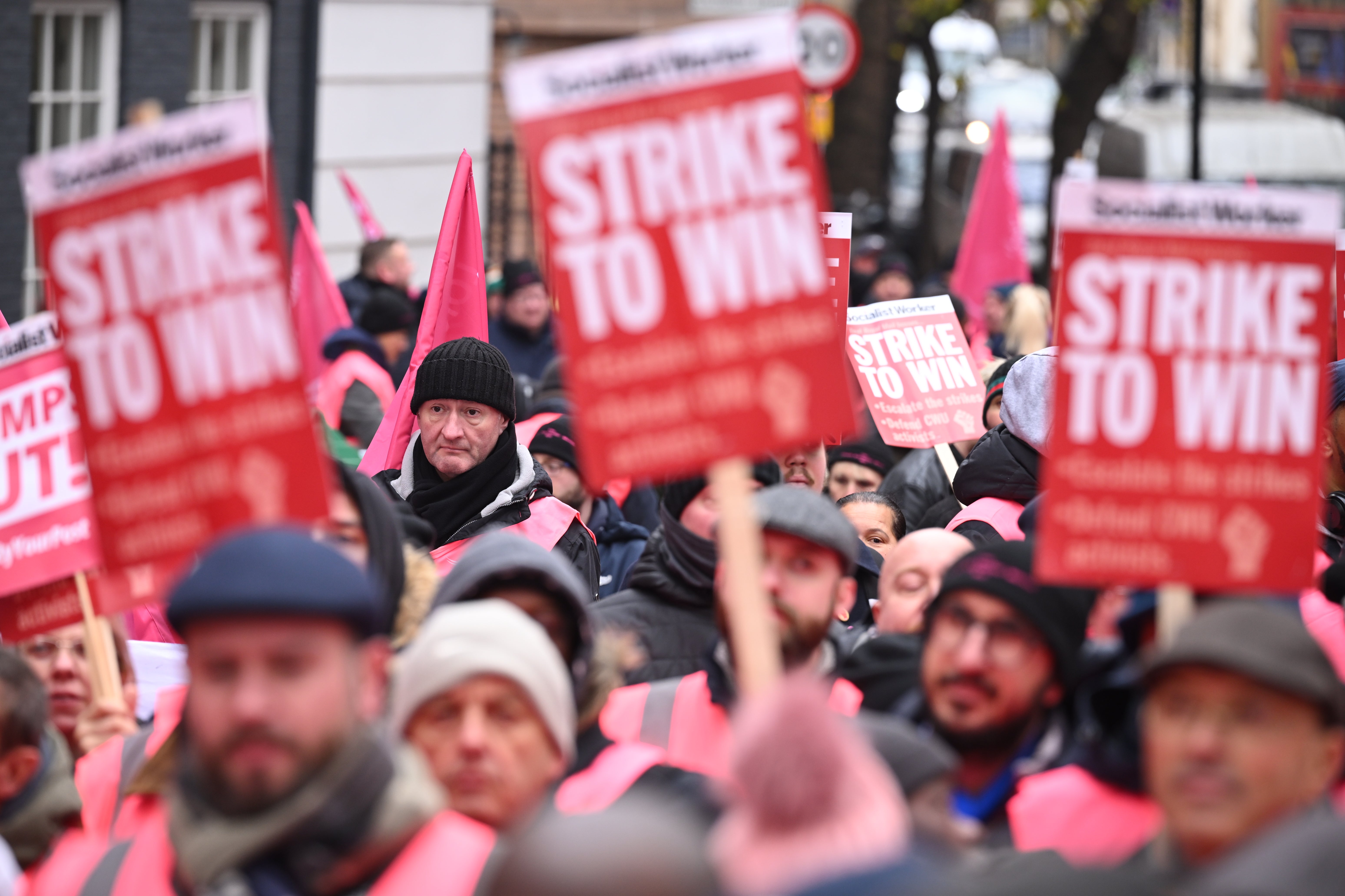 Striking mail workers and supporters march to Parliament Square on December 9, 2022