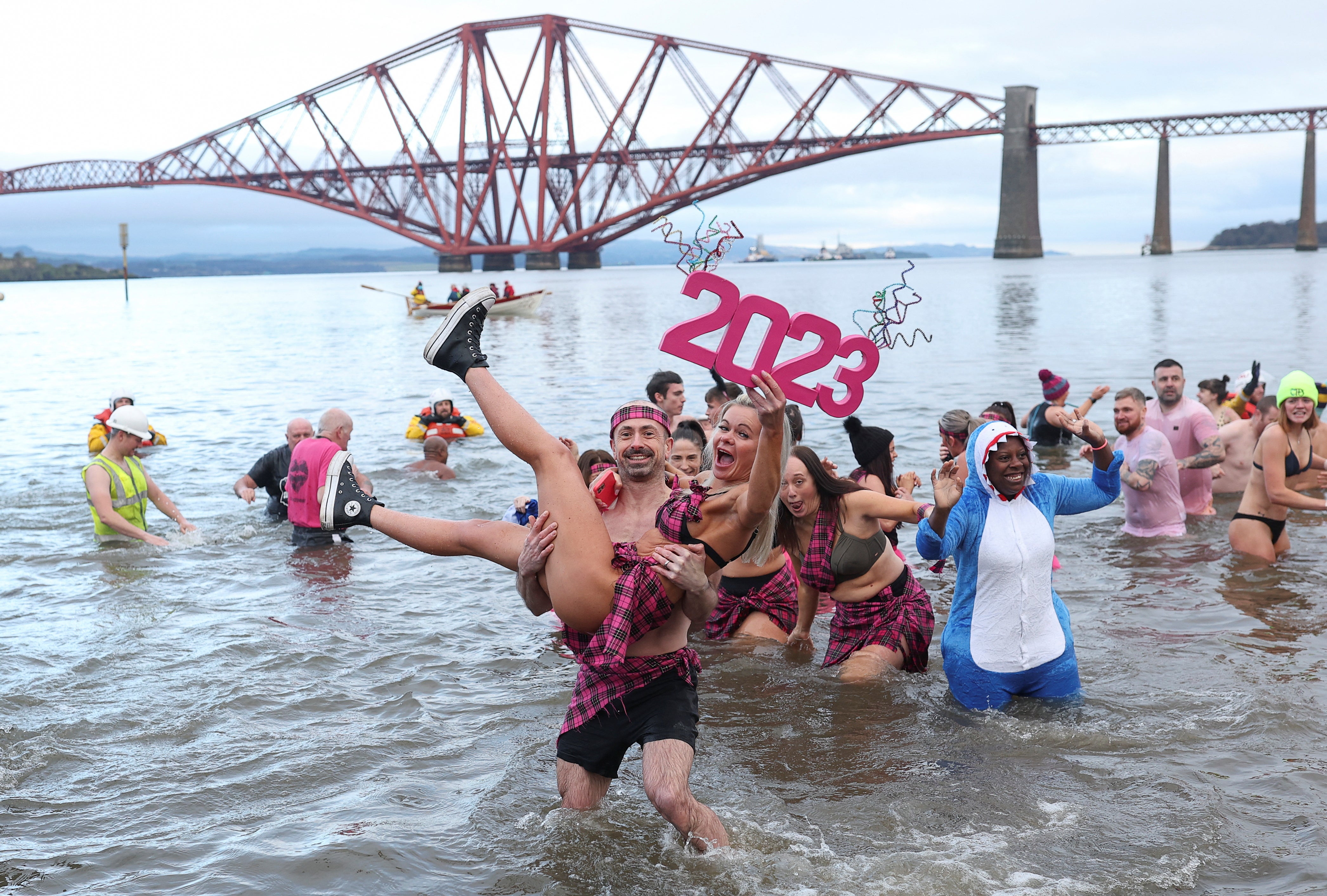 Revellers participate in a New Year’s Day swim, locally referred to as a ‘loony dook’, at South Queensferry in Scotland