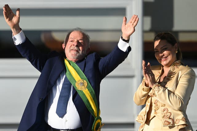 <p>Brazil’s new President Luiz Inacio Lula da Silva gestures at supporters next to his wife </p>