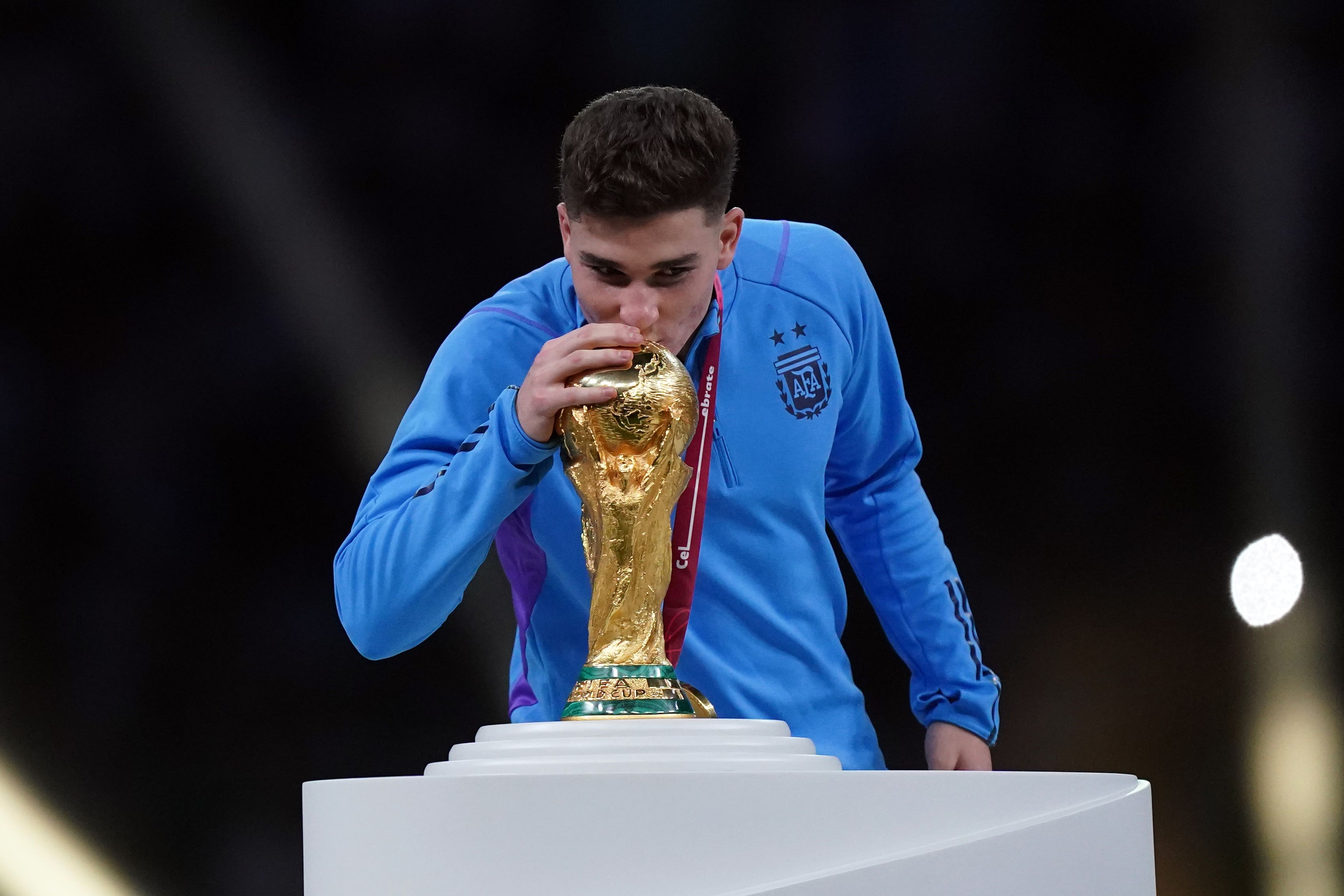 Julian Alvarez kisses the World Cup trophy (Mike Egerton/PA)