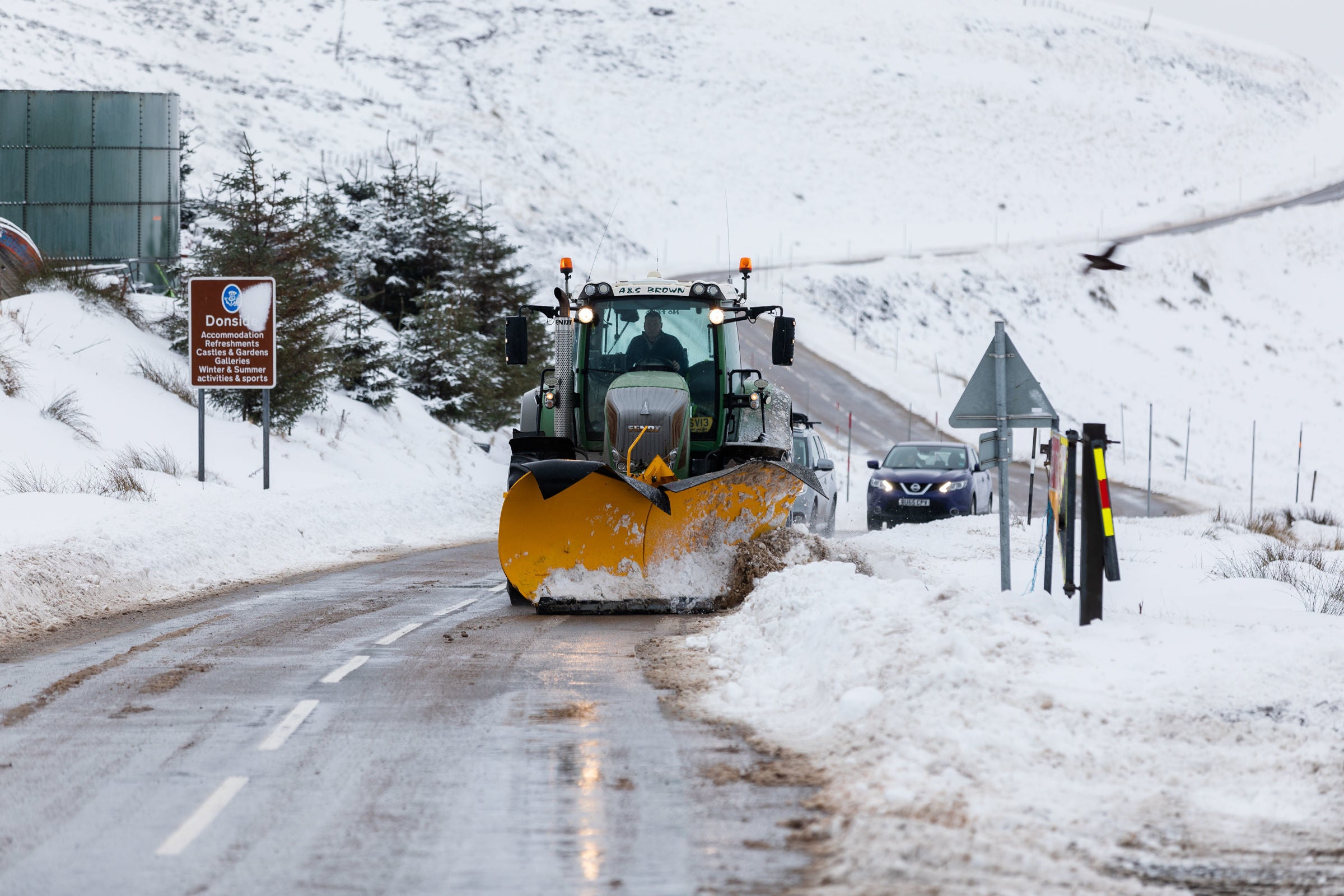 A snow plough clears the A939 after heavy snowfall in the Scottish Highlands