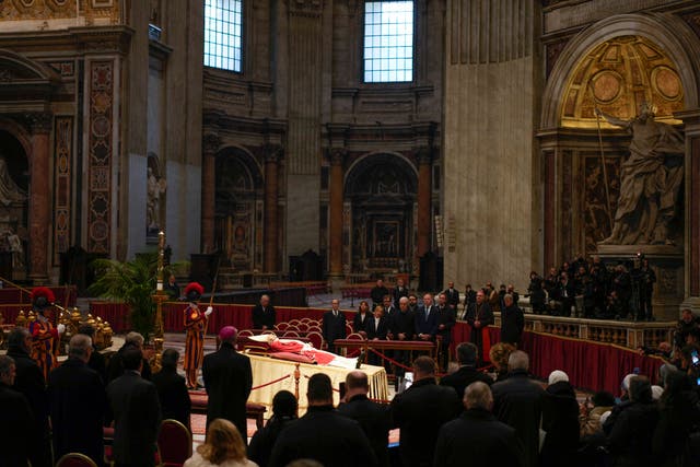 <p>People look at the body of late Pope Emeritus Benedict XVI laid out in state inside St Peter's Basilica at The Vatican</p>