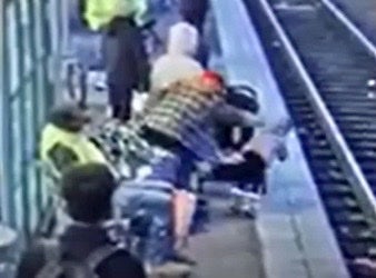 Footage captures moment a woman shoved a small child onto train tracks