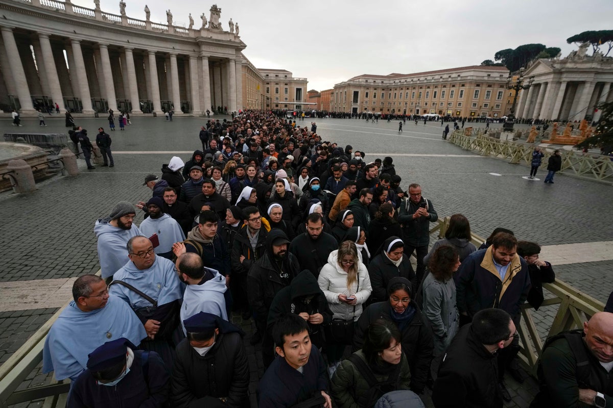 Tens of thousands of mourners pay respects to former Pope Benedict XVI as he lies in state