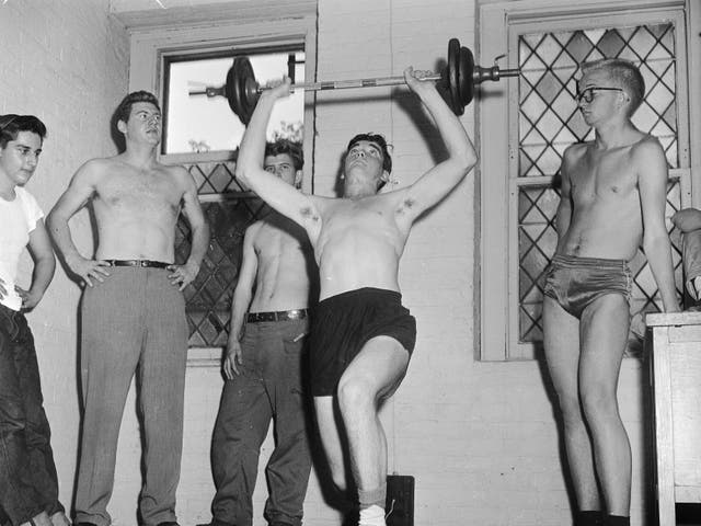 <p>Youths lift weights in 1950s New York. </p>