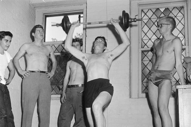 <p>Youths lift weights in 1950s New York. </p>