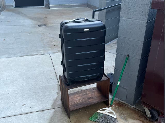 <p>Valerie Szybala’s suitcase pictured next to a dumpster</p>