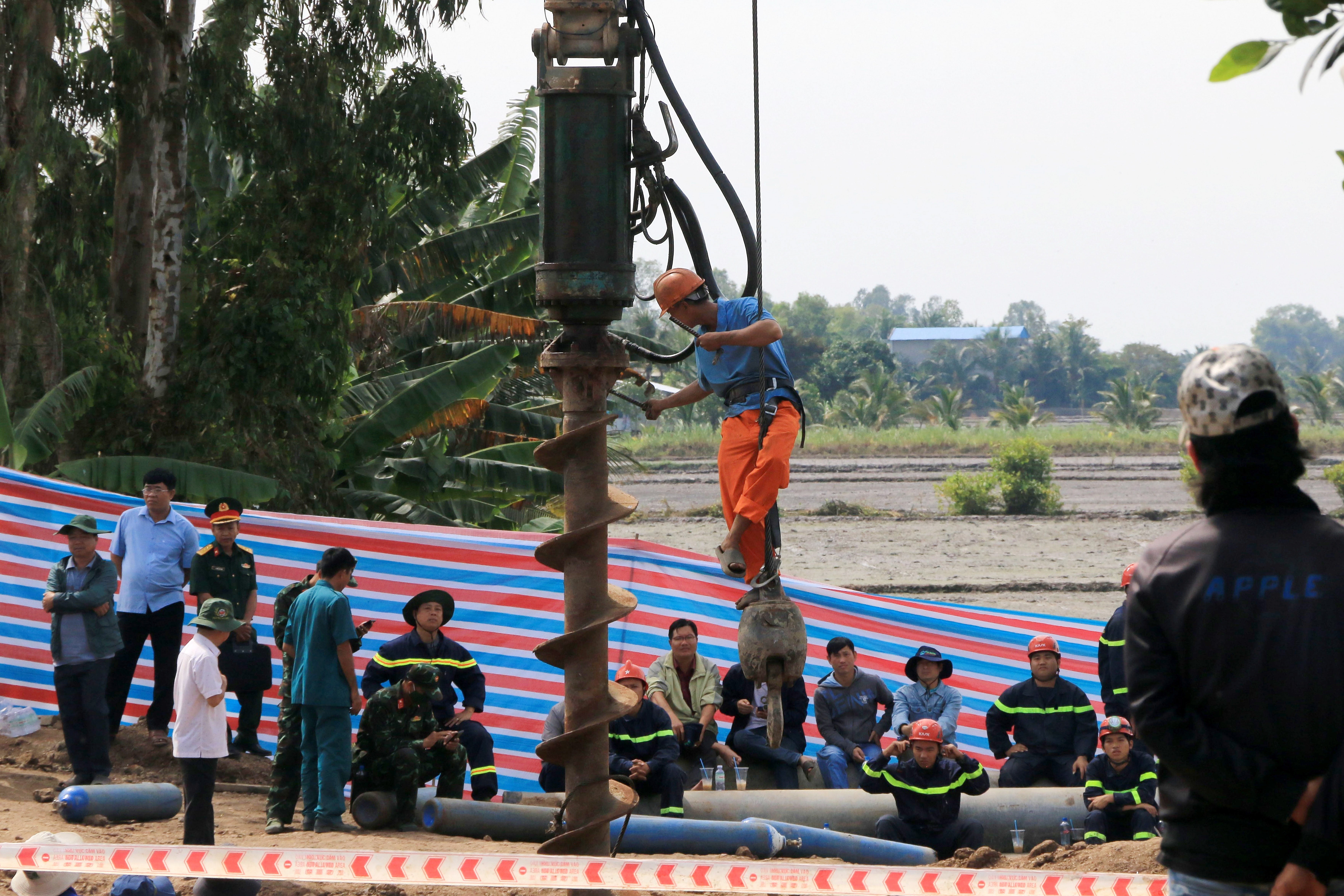 File photo: Rescuers who were attempting to free Vietnamese boy trapped in a shaft