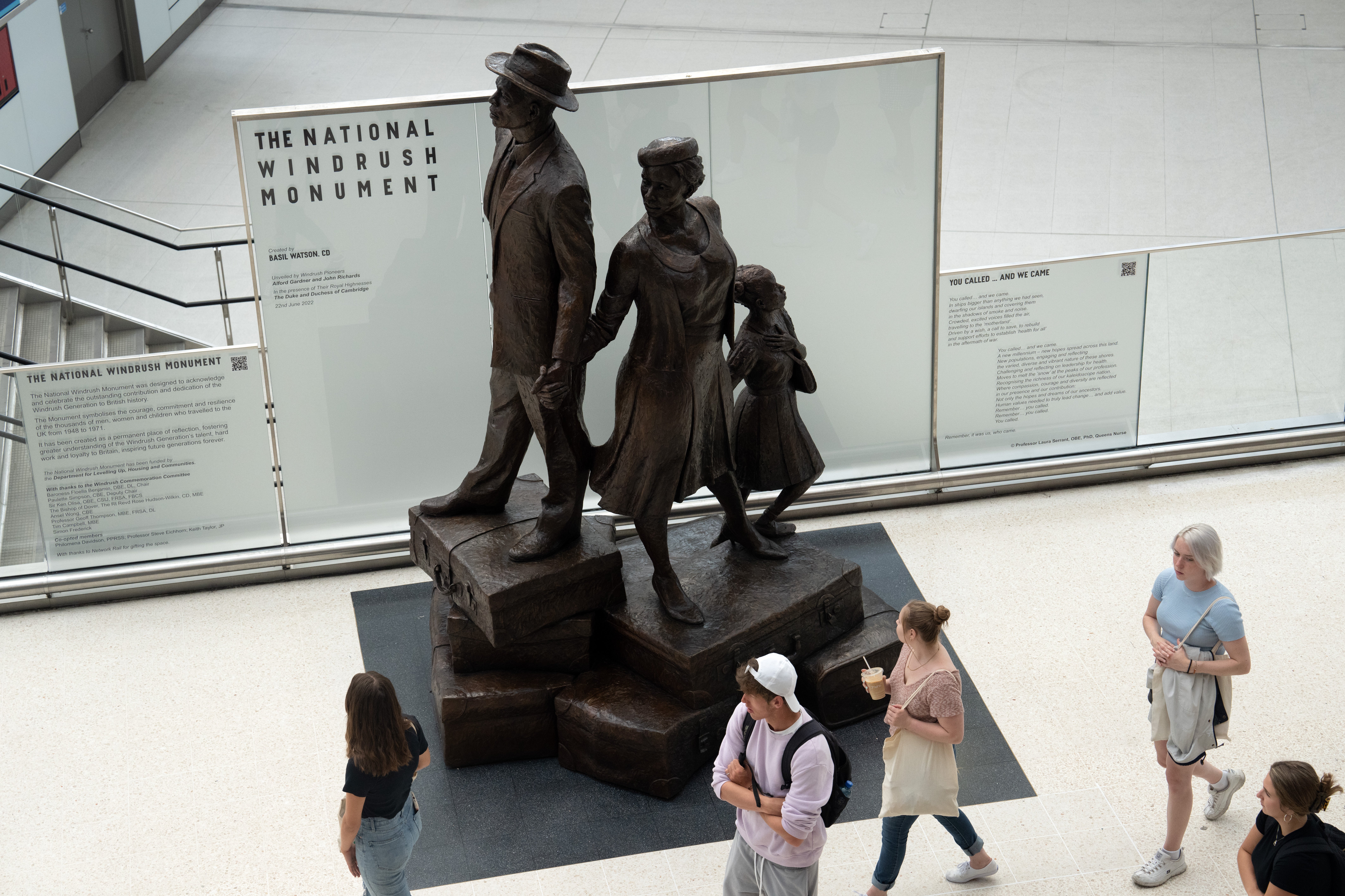People view the statue dedicated to the Windrush generation at Waterloo station unveiled in June. Today, voices from across the UK are speaking out about Windrush 75