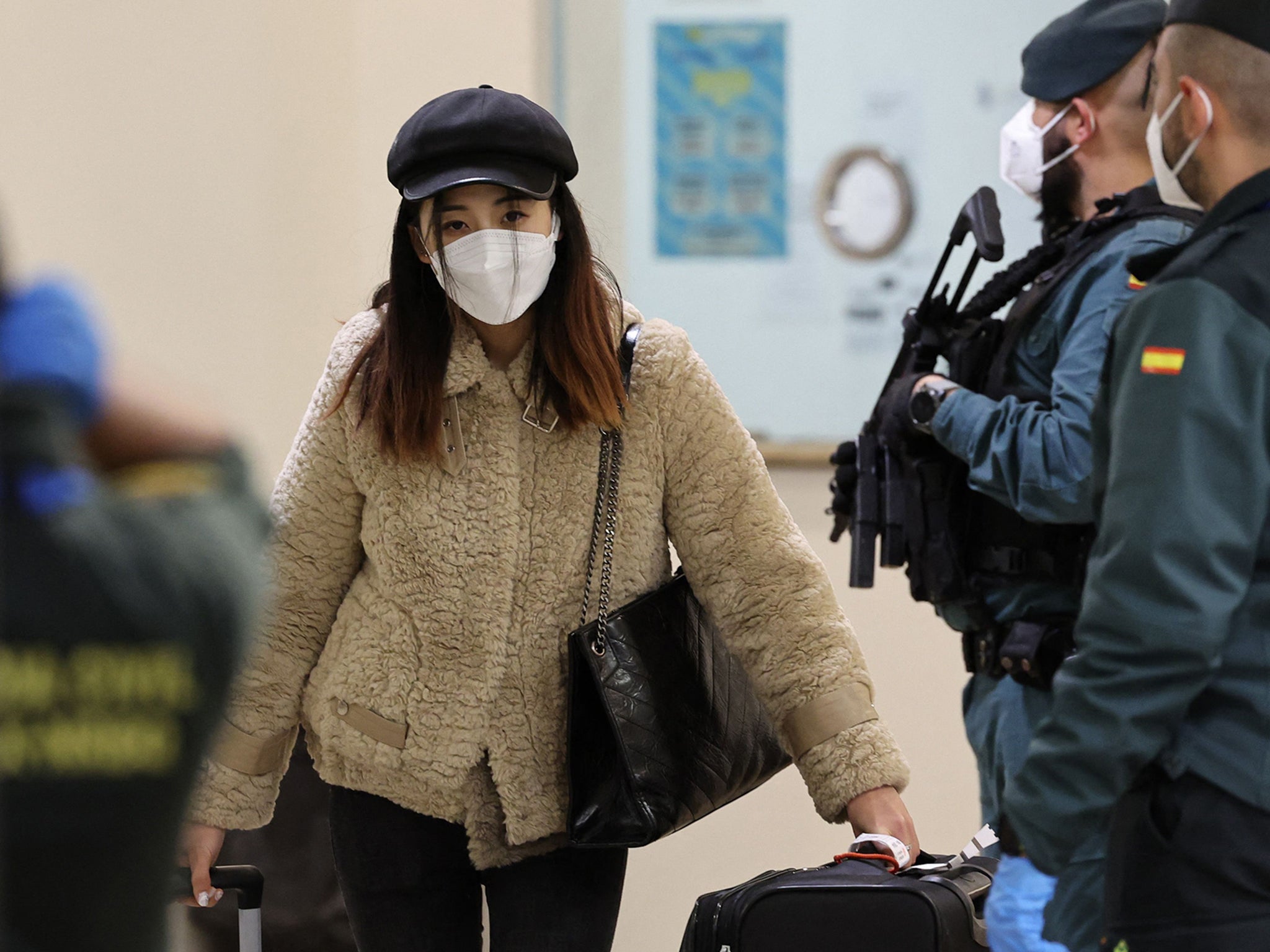 A passenger from Beijing leaves the terminal at Adolfo Suarez Madrid-Barajas airport in Madrid