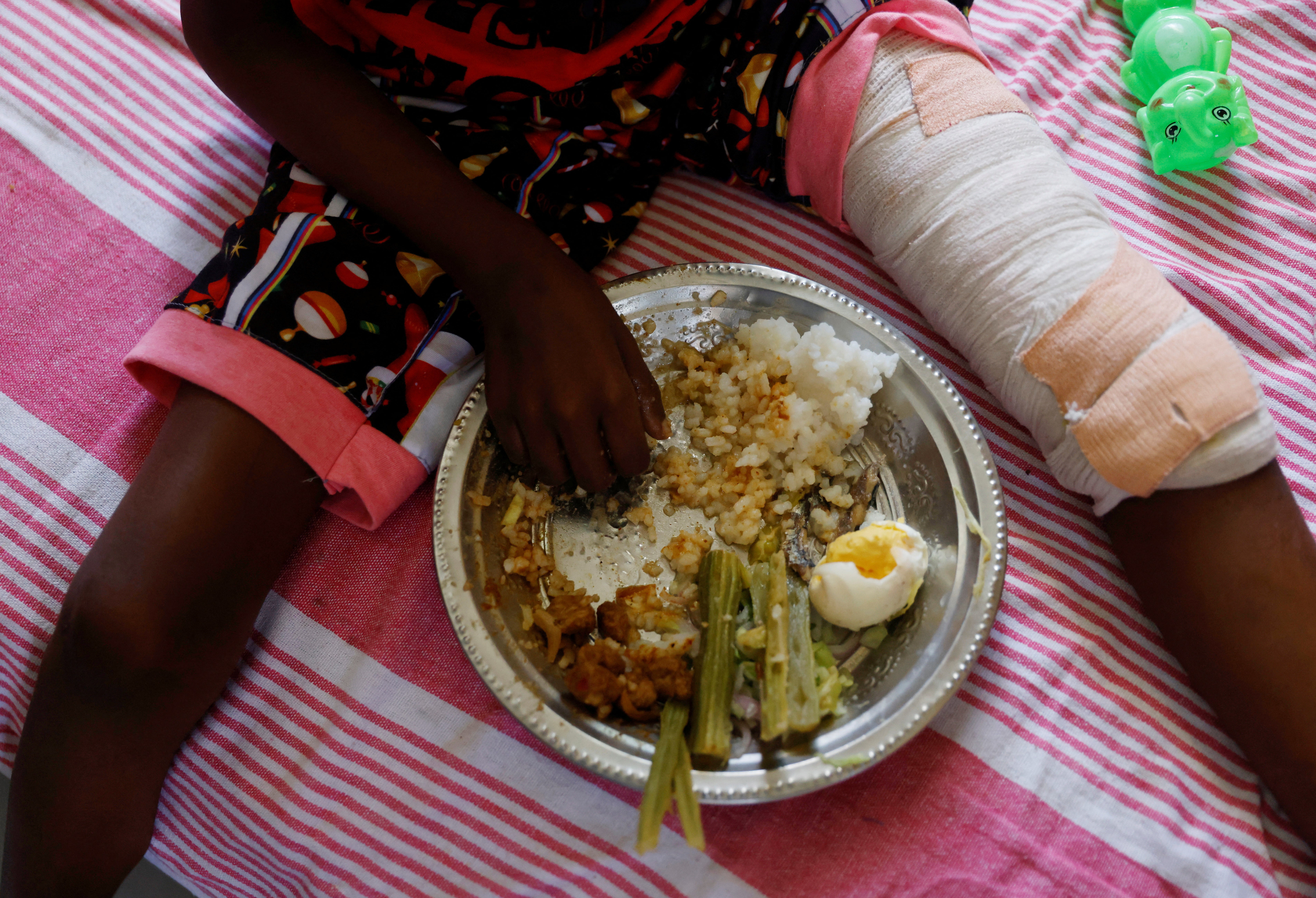 Enjoying some lunch on a bed at a cancer care transit home near Apeksha Hospital