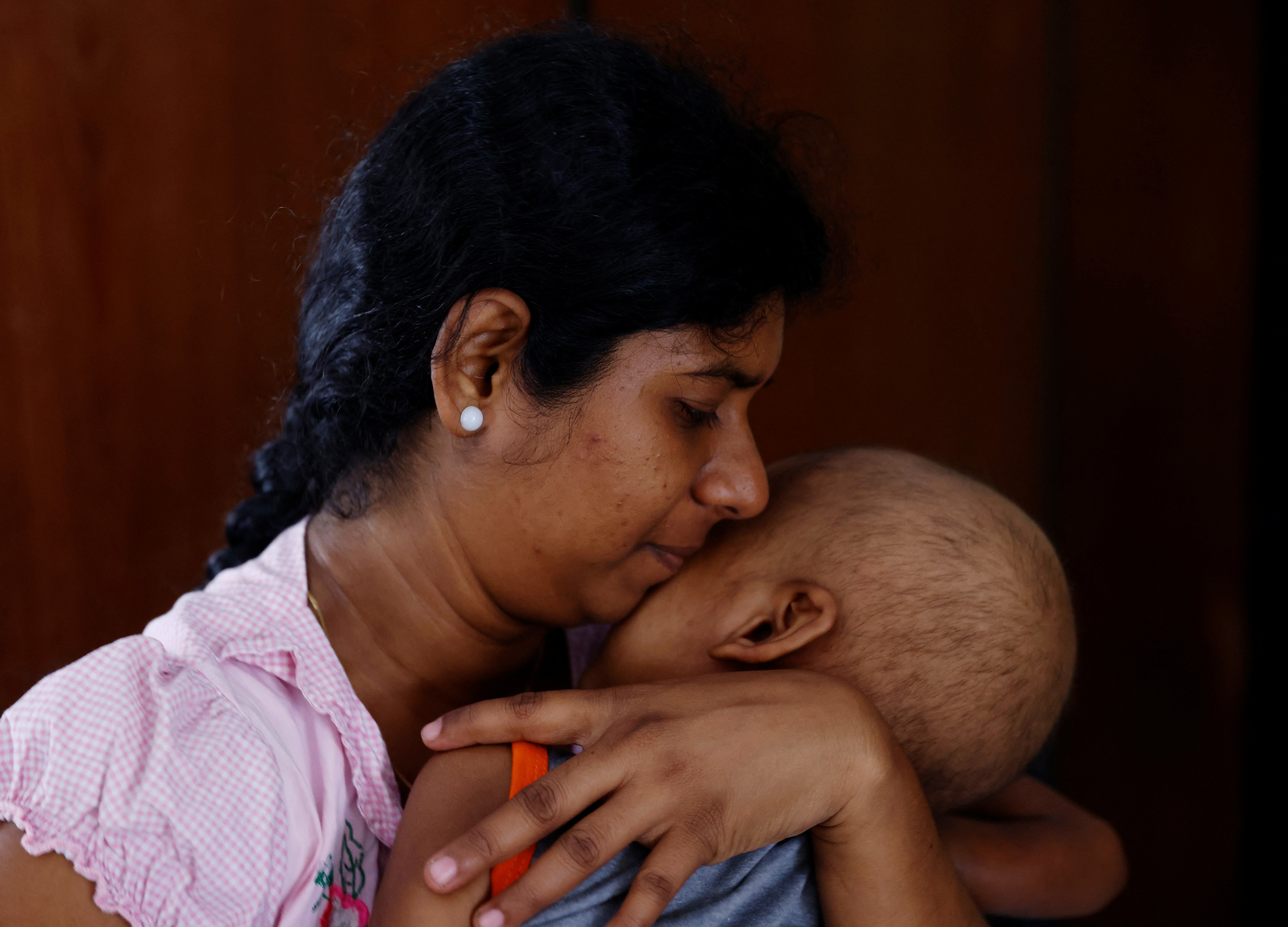 Sathiyaraj Silaksana holds her five-year-old son S Saksan, who has leukaemia