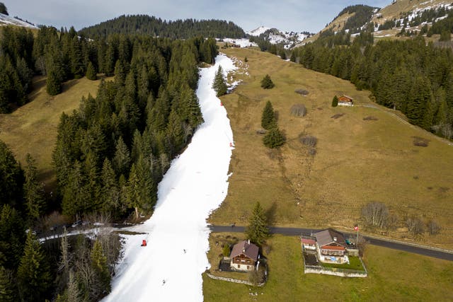 <p>Skiers using a ski slope with artificial snow in the alpine resort of Villars-sur-Ollon, Switzerland</p>