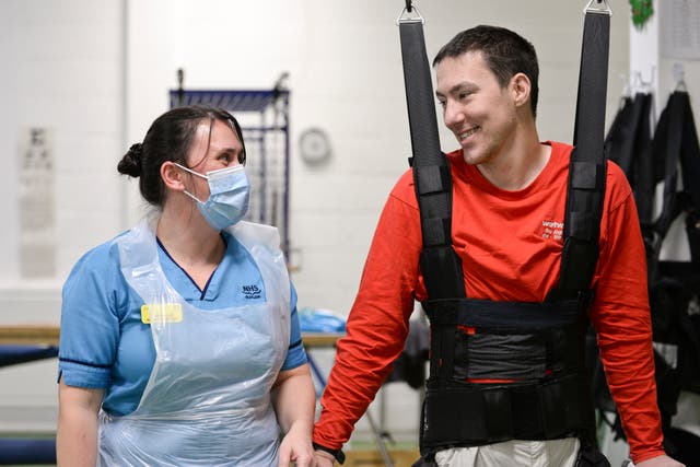 Physiotherapist Claire Lincoln with patient Luke Louden (Queen Elizabeth National Spinal Injuries Unit/PA)