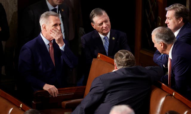 <p>House Republican leader Kevin McCarthy (R-CA) puts his hand to his face as he talks with Republican House colleagues on the House floor during voting as he runs for election to be the next Speaker of the House on the first day of the 118th Congress at the U.S. Capitol in Washington, U.S., January 3, 2023</p>