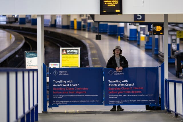 <p>A passenger waits for a train at Euston Station in London, Britain</p>