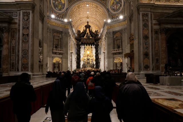 <p>Catholics queue in St Peter’s Basilica on Wednesday to pay their respects</p>