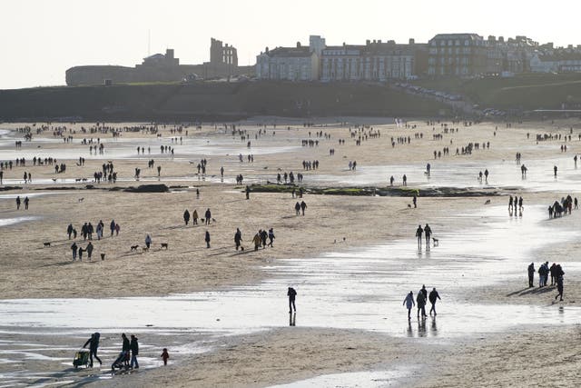 Families on Tynemouth Longsands Beach in Tynemouth in the North East of England (Stefan Rousseau/PA)