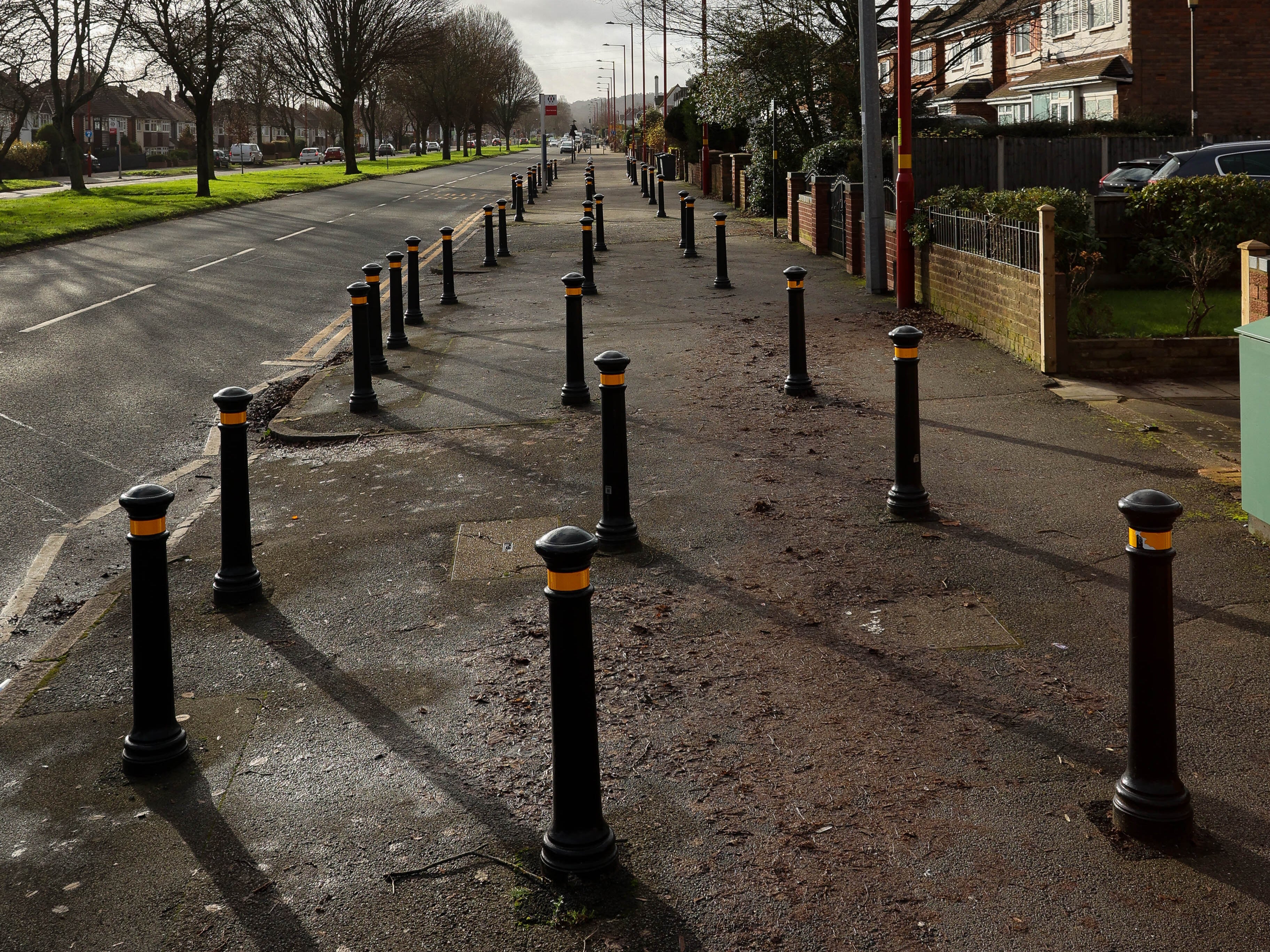 Residents have complained about bollards on a pavement in Birmingham used to stop parking near to the school