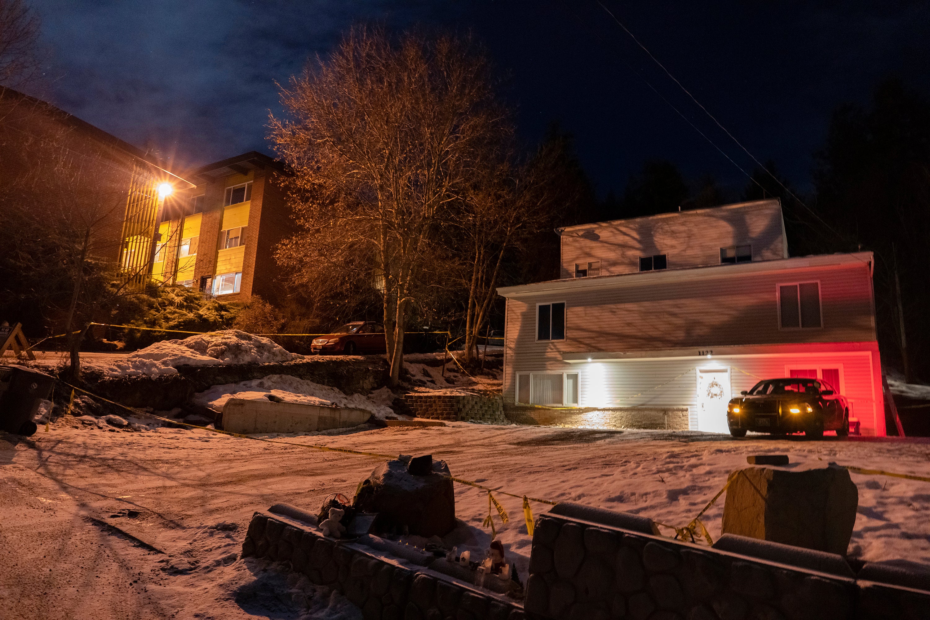 A private security officer sits in a vehicle on Jan. 3, 2023, in front of the house in Moscow, Idaho where four University of Idaho were murdered