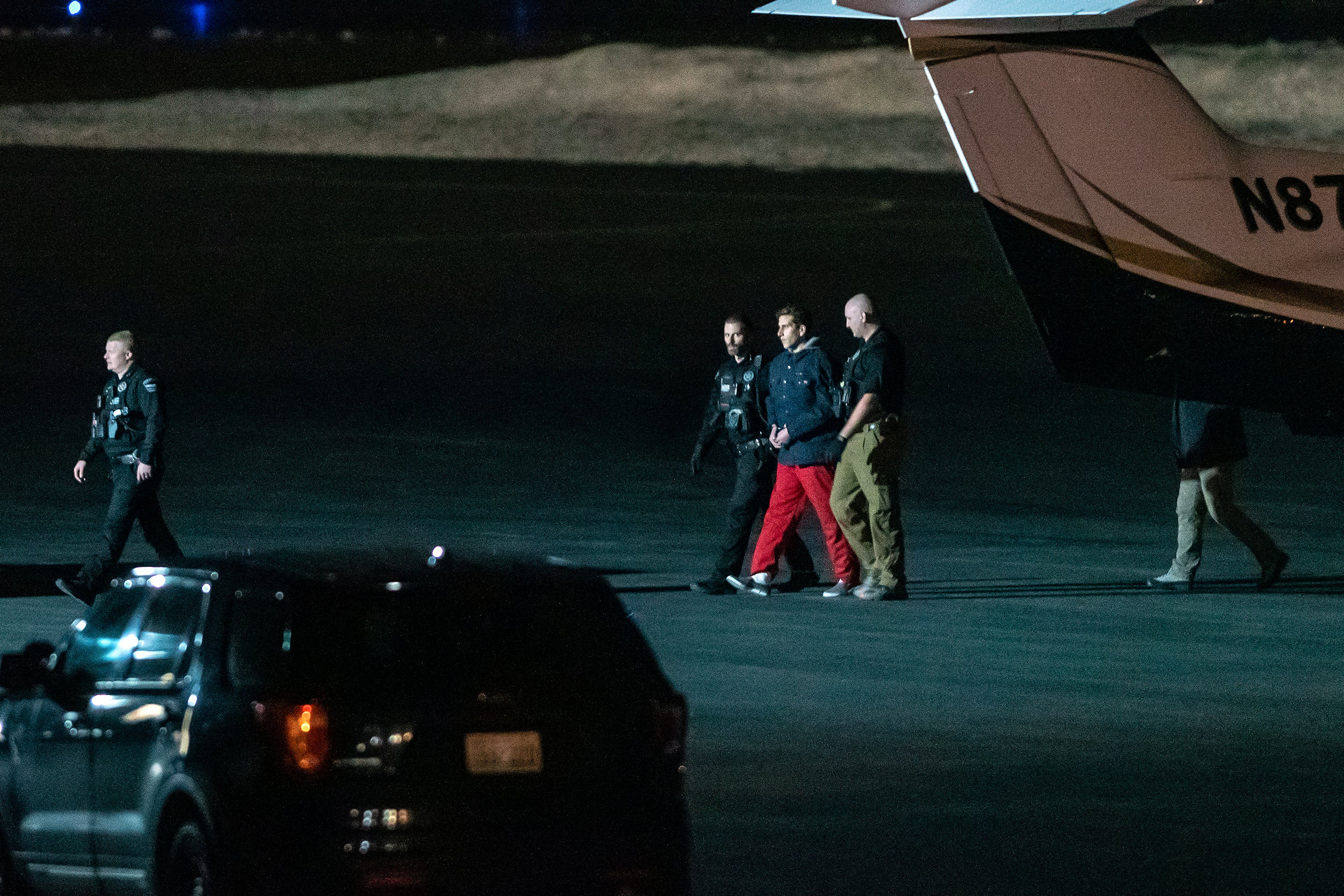 Bryan Kohberger is escorted from the plane at Pullman-Moscow Regional Airport on Wednesday