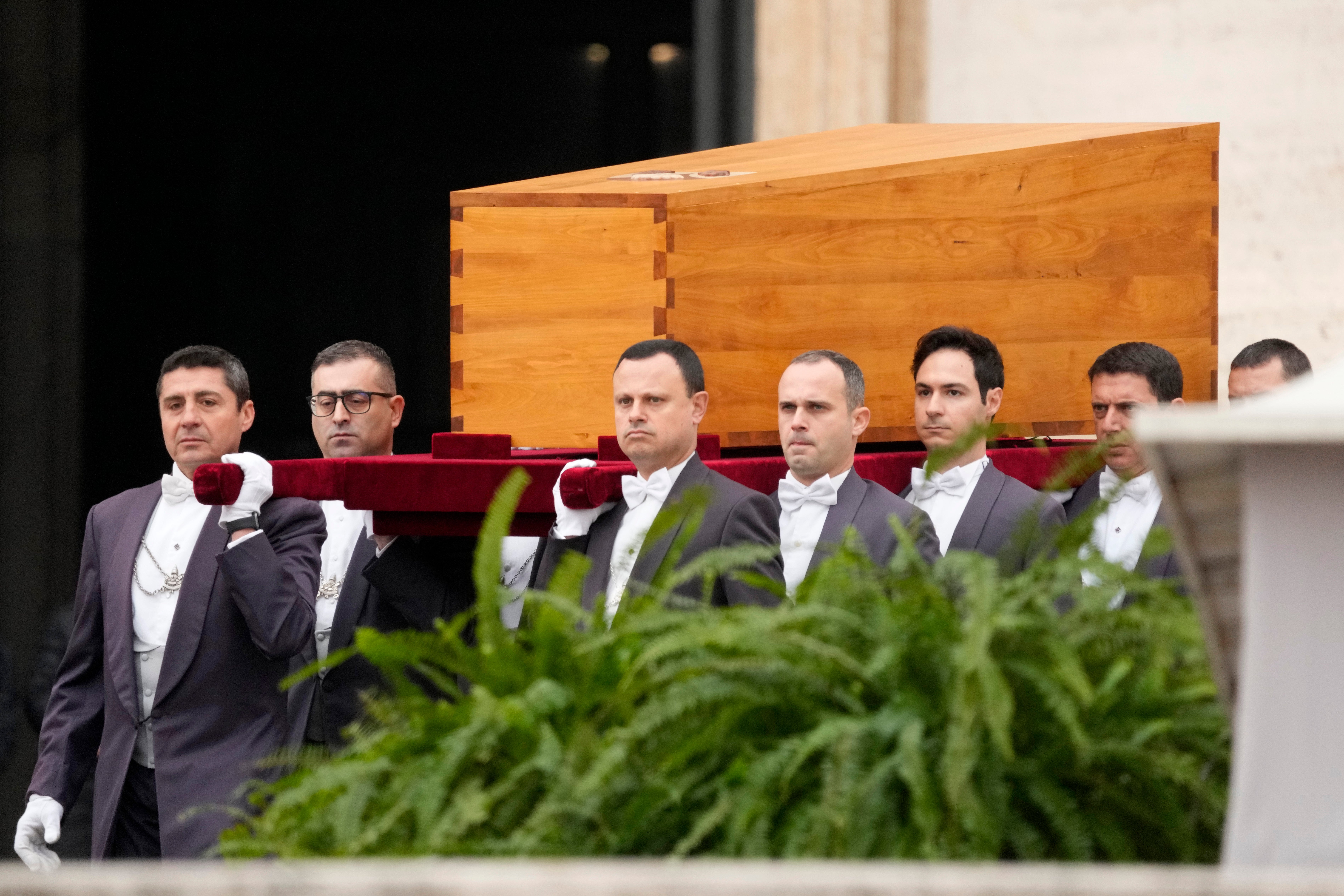 The coffin of Benedict XVI is carried into view for the start of his funeral