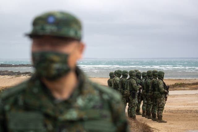 <p>Taiwan military personnel stand guard during the visit of president Tsai Ing-wen at a military base in Penghu, Taiwan on 30 December 2022</p>