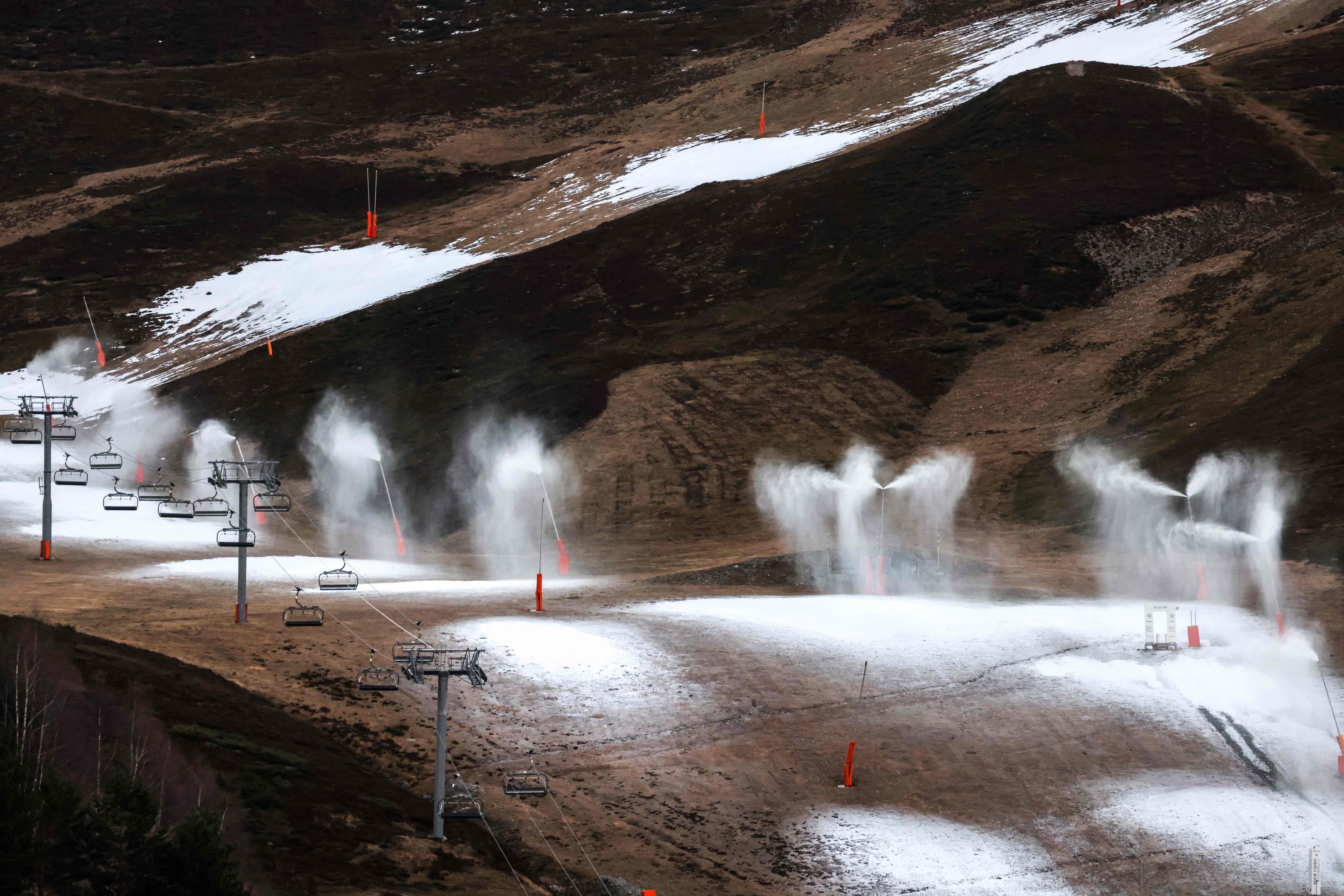 Snow cannons operate due to lack of snow at the Peyragudes ski resort, southwestern France