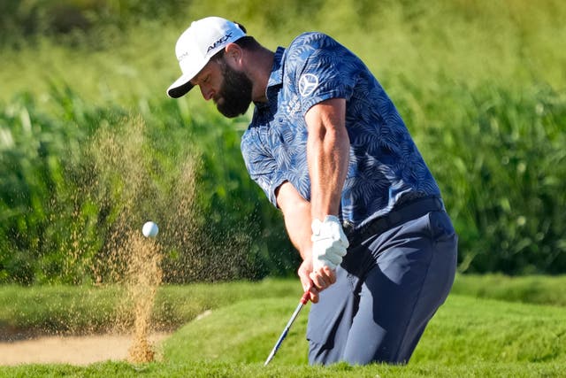 Low scores were abound in the first round of the Sentry Tournament of Champions in Hawaii, with Jon Rahm, Collin Morikawa and JJ Spaun all sharing the lead on nine under par (Matt York/AP)