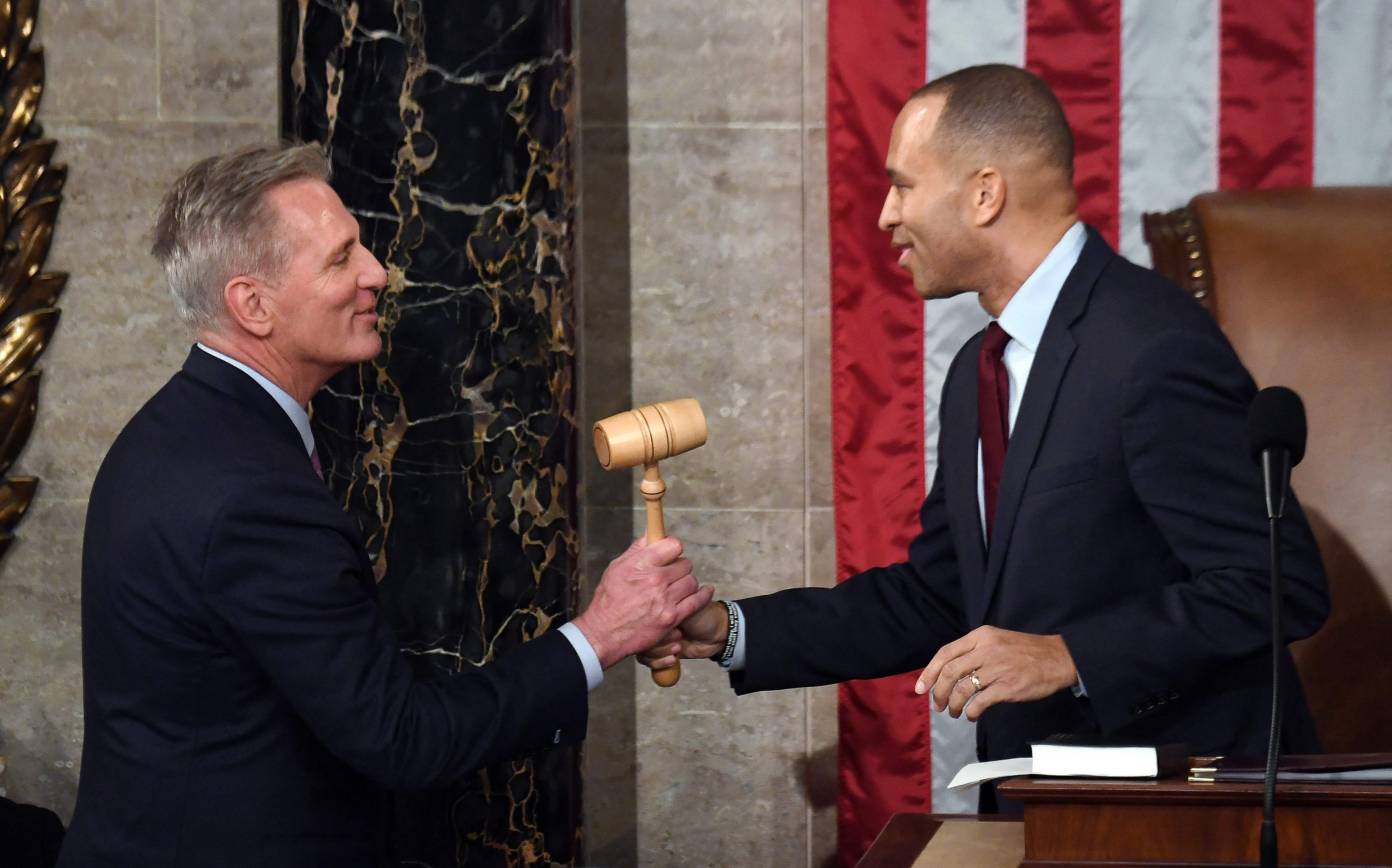 Minority leader Hakeem Jeffries gives the gavel to newly elected speaker of the US House of Representatives Kevin McCarthy after being annointed on the 15th round of voting at the US Capitol in Washington, DC, on 7 January 2023