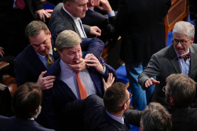 <p>Richard Hudson, left, pulls Rep. Mike Rogers back as he lunges at talk Matt Gaetz during the 14th round of voting for speaker. </p>