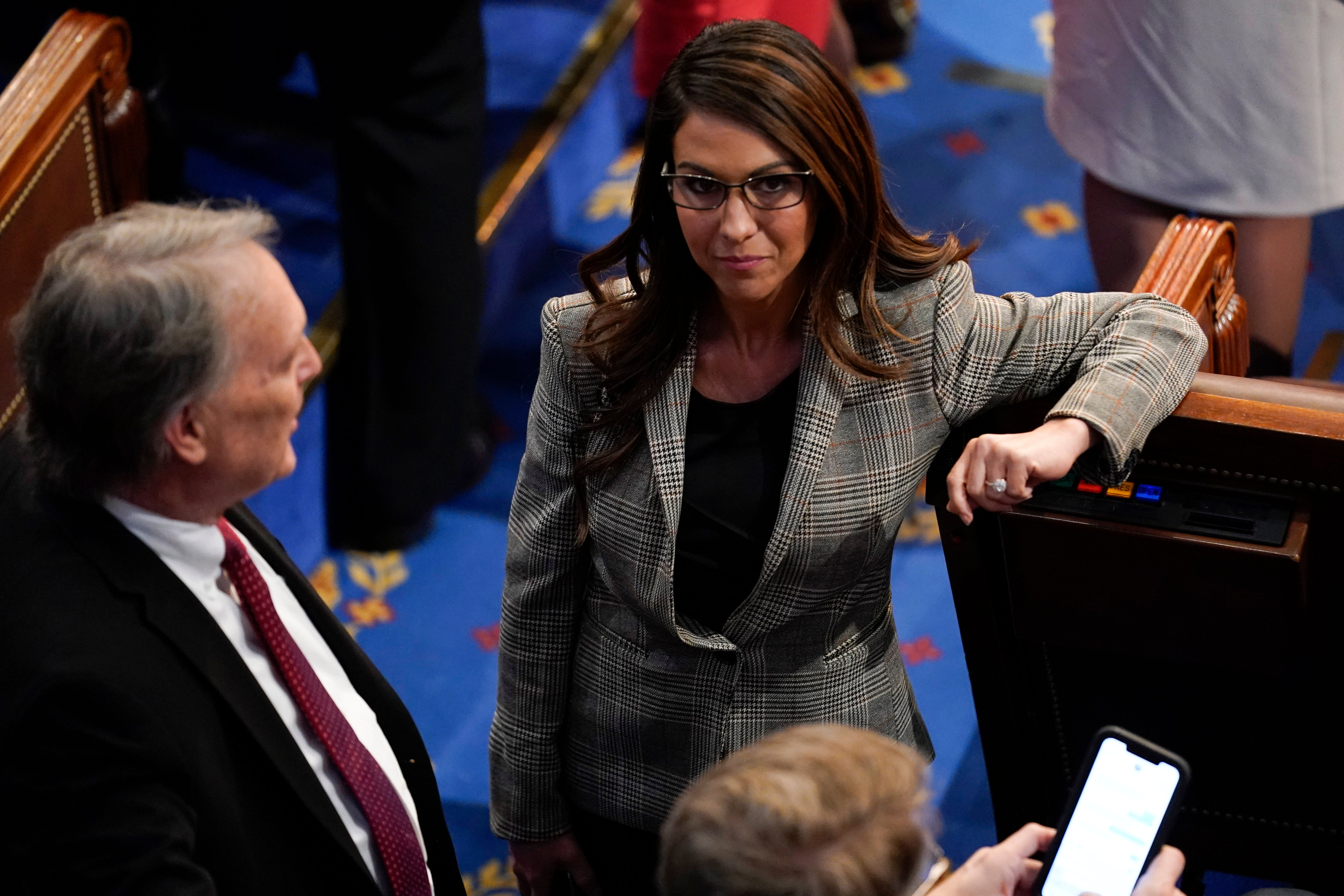 Republican Representative Lauren Boebert of Colorado, talks with Representative Andy Biggs of Arizona