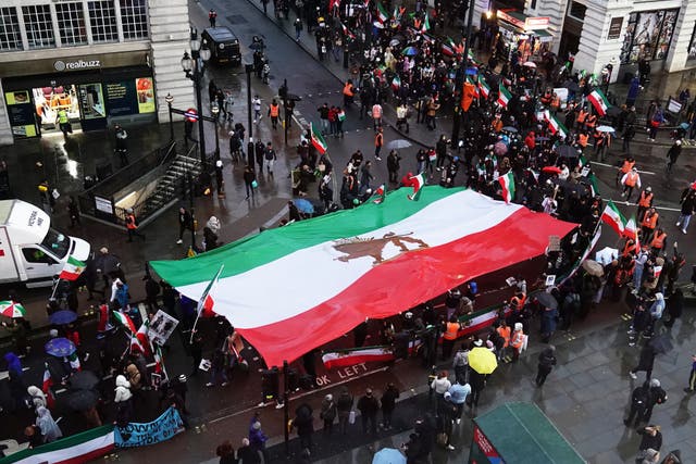 Demonstrators march through Piccadilly Circus in London, to protest against the Islamic Republic in Iran following the death of Mahsa Amini (Aaron Chown/PA)