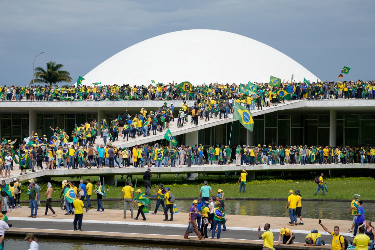 Brazil riots – live: Police surround Bolsonaro supporter camp after Congress attack