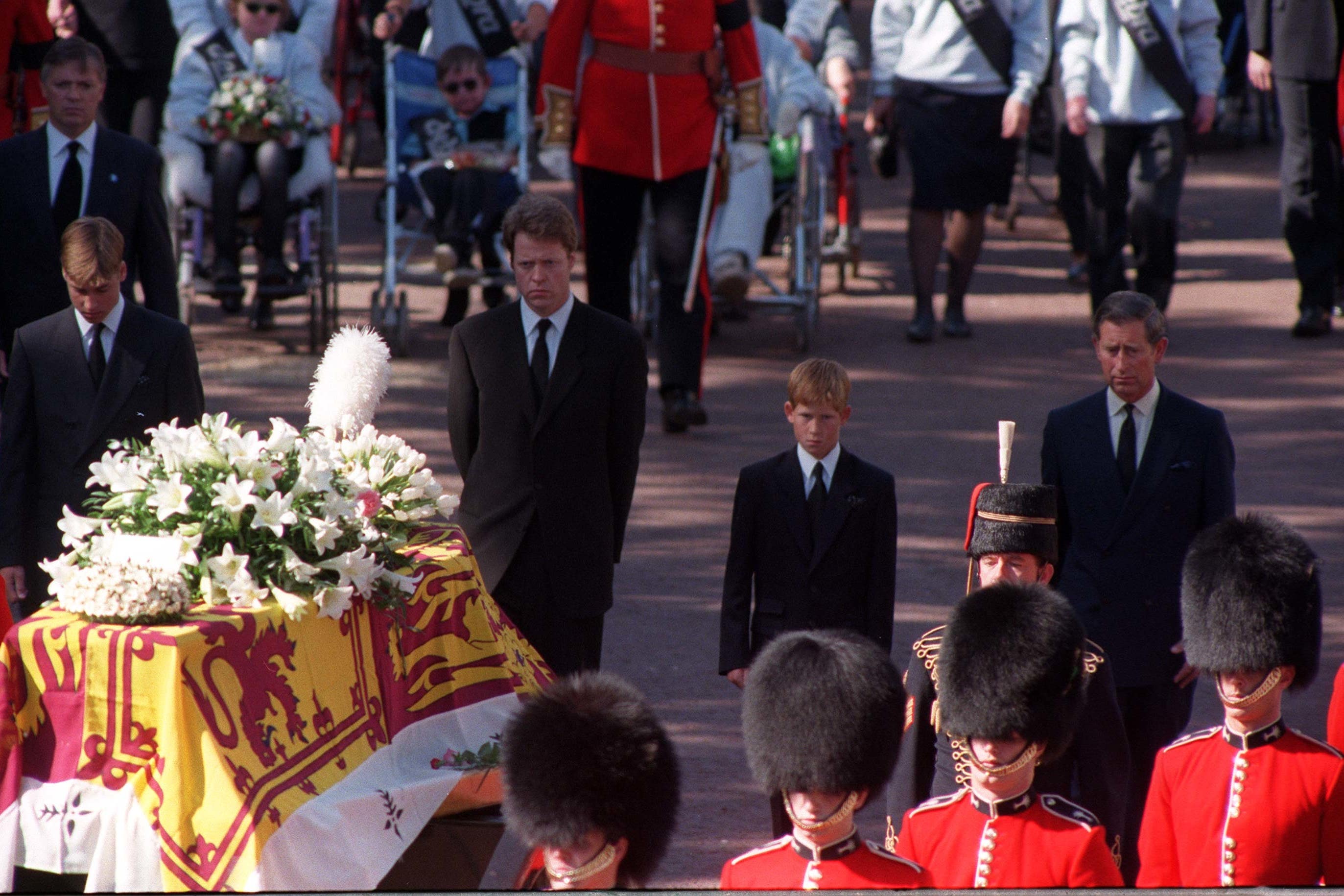 Princes William and Harry, the sons of Diana, Princess of Wales, her brother Earl Spencer and her former husband, the Prince of Wales, walking behind her coffin as the funeral procession approaches Westminster Abbey (Adam Butler/PA)