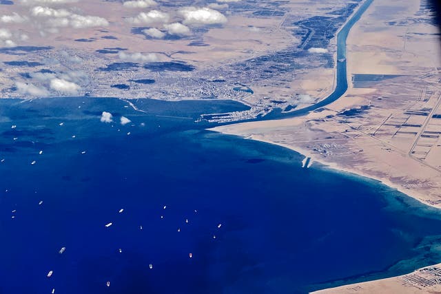 <p>File: An aerial view from the porthole of a commercial plane shows stranded ships waiting in queue in the Gulf of Suez to cross the Suez Canal at its southern entrance near the Red Sea port city of Suez</p>